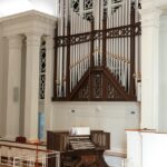 Church organ with large pipes and console.