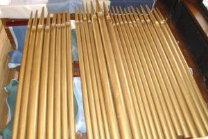 Rows of gold organ pipes on floor