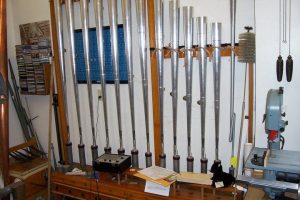 Organ pipes and tools in a workshop.